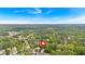 An aerial view of the property showcases its location in a lush, green neighborhood with mature trees and blue sky at 4380 Laurian Nw Dr, Kennesaw, GA 30144