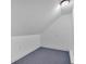 Finished attic with carpeting and neutral walls, showing the ceiling design at 4380 Laurian Nw Dr, Kennesaw, GA 30144
