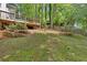Expansive backyard featuring a wooden deck, steps, and lush greenery, perfect for outdoor entertaining at 4380 Laurian Nw Dr, Kennesaw, GA 30144