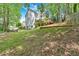 Exterior view of the home showcasing the large backyard with a deck and lawn, offering a serene outdoor space at 4380 Laurian Nw Dr, Kennesaw, GA 30144