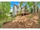 Backyard view with a deck, lush landscaping, and mature trees, creating a private and tranquil environment at 4380 Laurian Nw Dr, Kennesaw, GA 30144
