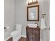 Charming powder room with a rustic vanity, vessel sink, and ornate mirror at 4380 Laurian Nw Dr, Kennesaw, GA 30144