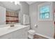 Clean bathroom vanity, countertop, and mirror next to toilet and shower with curtain at 4380 Laurian Nw Dr, Kennesaw, GA 30144