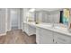Bright bathroom with a dual sink vanity, hard wood flooring and white cabinets at 4380 Laurian Nw Dr, Kennesaw, GA 30144
