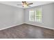 Bright and airy bedroom with new flooring, a ceiling fan, and large window offering natural light at 4380 Laurian Nw Dr, Kennesaw, GA 30144