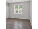Bright bedroom featuring hardwood floors, neutral walls and a window overlooking the yard at 4380 Laurian Nw Dr, Kennesaw, GA 30144