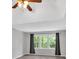 Bedroom with a trey ceiling, ceiling fan, hardwood flooring, and gray drapes at 4380 Laurian Nw Dr, Kennesaw, GA 30144
