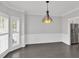 Bright dining room featuring wainscoting detail and a modern light fixture, perfect for Gathering dinners at 4380 Laurian Nw Dr, Kennesaw, GA 30144