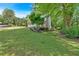 Beautiful home exterior featuring a well-manicured lawn and mature trees, blending with the natural surroundings at 4380 Laurian Nw Dr, Kennesaw, GA 30144
