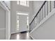 Bright foyer with staircase, stylish dark floors, and white trim at 4380 Laurian Nw Dr, Kennesaw, GA 30144