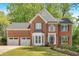 Beautiful brick home features a two-car garage and manicured lawn at 4380 Laurian Nw Dr, Kennesaw, GA 30144