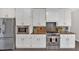 Modern kitchen with stainless steel appliances, white cabinetry, and great lighting at 4380 Laurian Nw Dr, Kennesaw, GA 30144