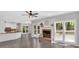 Open living room features a brick fireplace, ceiling fan, and lots of natural light at 4380 Laurian Nw Dr, Kennesaw, GA 30144