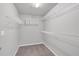 A spacious walk-in closet with shelving units and carpeted floors provides ample storage space at 4380 Laurian Nw Dr, Kennesaw, GA 30144