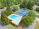 Aerial view of community pool and tennis courts with surrounding greenery at 4813 Fernie Ne Ct, Marietta, GA 30068