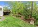 Grassy backyard and landscaped area with foot bridge at 4813 Fernie Ne Ct, Marietta, GA 30068