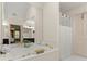 Bright bathroom with a tub, and door that leads to another bathroom at 4813 Fernie Ne Ct, Marietta, GA 30068