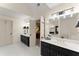 Bathroom featuring double sinks with dark cabinets and stylish lighting fixtures at 4813 Fernie Ne Ct, Marietta, GA 30068