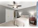 Inviting bedroom with soft lighting, a ceiling fan, and a comfortable bed for a restful night's sleep at 4813 Fernie Ne Ct, Marietta, GA 30068