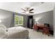 Relaxing bedroom with a large window offering natural light, a ceiling fan, and coordinated decor at 4813 Fernie Ne Ct, Marietta, GA 30068