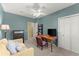 Bright room with a ceiling fan and natural light featuring a comfy sofa and a desk at 4813 Fernie Ne Ct, Marietta, GA 30068