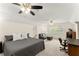 Cozy bedroom featuring neutral tones, a ceiling fan, comfortable seating area, and a well-lit workspace at 4813 Fernie Ne Ct, Marietta, GA 30068