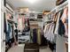 Walk-in closet with custom shelves, hanging rods, and ample storage space at 4813 Fernie Ne Ct, Marietta, GA 30068