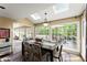 Sunlit dining room featuring skylights, a modern chandelier, and views of the outdoor deck and lush greenery at 4813 Fernie Ne Ct, Marietta, GA 30068