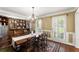 Dining room featuring a large wood table, chandelier, and large china cabinet at 4813 Fernie Ne Ct, Marietta, GA 30068