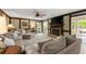 Cozy living room featuring a fireplace, large sectional sofa, and access to the back patio at 4813 Fernie Ne Ct, Marietta, GA 30068