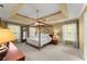 Spacious main bedroom with a four-poster bed, ceiling fan, and natural light at 4813 Fernie Ne Ct, Marietta, GA 30068