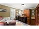 Cozy home office featuring custom built-ins, plantation shutters, and hardwood floors at 4813 Fernie Ne Ct, Marietta, GA 30068