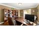 Home office with bookshelves, a large desk, and a view of the foyer at 4813 Fernie Ne Ct, Marietta, GA 30068