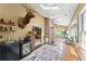 Bright sunroom with brick accent wall, multiple windows, a beverage center, and access to other living areas at 4813 Fernie Ne Ct, Marietta, GA 30068