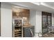 Basement wine bar with stainless steel wine fridge and brick accents provides a sophisticated touch at 4813 Fernie Ne Ct, Marietta, GA 30068