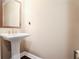 Elegant powder room with a pedestal sink and classic design at 5022 Towneship Creek Rd, Roswell, GA 30075