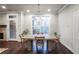 Bright dining room with a modern chandelier and a large window overlooking the backyard at 5022 Towneship Creek Rd, Roswell, GA 30075