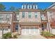 Charming brick townhome with a two-car garage and a well-maintained front yard at 5022 Towneship Creek Rd, Roswell, GA 30075