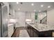 Modern kitchen with stainless steel appliances, granite countertops, and island with bar seating at 5022 Towneship Creek Rd, Roswell, GA 30075