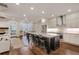 Spacious kitchen with granite countertops, stainless steel appliances, and modern island with barstool seating at 5022 Towneship Creek Rd, Roswell, GA 30075