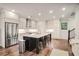 Bright kitchen featuring stainless steel appliances, granite countertops, and a large kitchen island at 5022 Towneship Creek Rd, Roswell, GA 30075