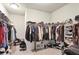 Well-organized walk-in closet with shelves and hanging rods at 5022 Towneship Creek Rd, Roswell, GA 30075