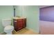 A bathroom features a wooden cabinet sink and a toilet at 5840 Harrier Ln, Atlanta, GA 30349