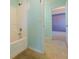 A bathroom has a tub and shower with a tile floor at 5840 Harrier Ln, Atlanta, GA 30349