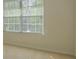 Bright room featuring a large window with blinds, carpet flooring, and neutral wall paint at 5840 Harrier Ln, Atlanta, GA 30349