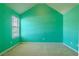 A carpeted bedroom with a window allows for natural light at 5840 Harrier Ln, Atlanta, GA 30349