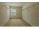 Walk-in closet with white walls, carpeted floors, and metal shelving at 5840 Harrier Ln, Atlanta, GA 30349