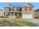 Charming two-story brick home with a well-manicured lawn and inviting front porch at 5840 Harrier Ln, Atlanta, GA 30349