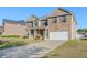 Brick two-story home with attached garage and driveway, complemented by a neat front lawn at 5840 Harrier Ln, Atlanta, GA 30349