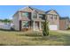 This two-story brick and siding home has a well manicured front lawn and a two car garage at 5840 Harrier Ln, Atlanta, GA 30349